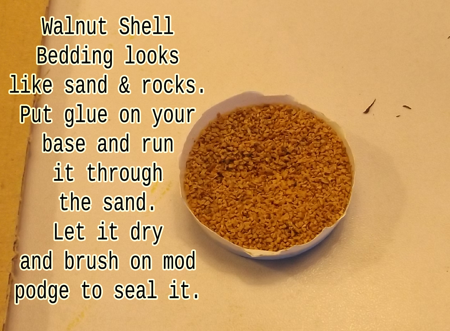 Put some Walnut Shell Bedding in a cup. Use some glue and presto! Miniature ground cover.